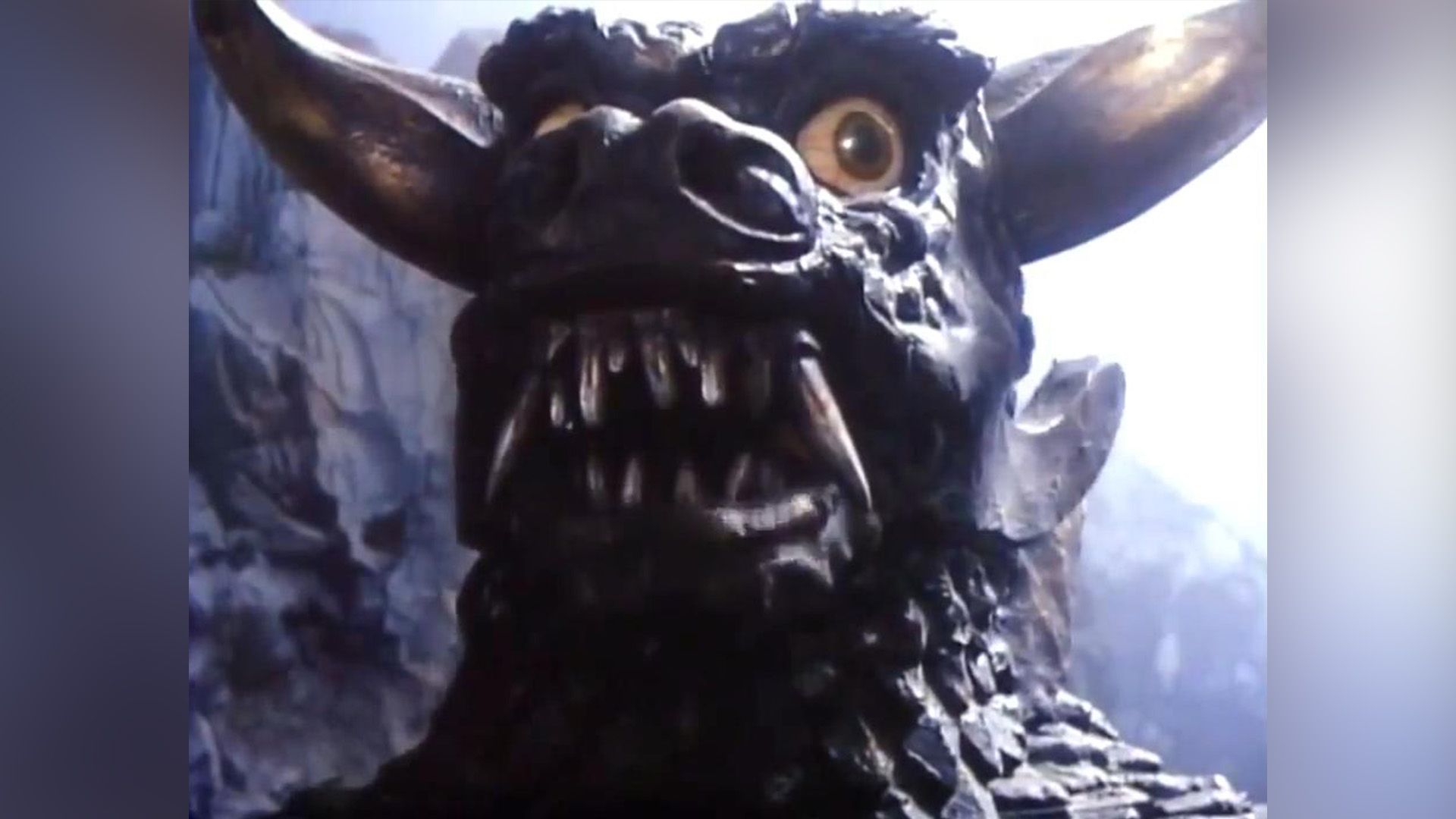 Close-up of an evil fantastic monster with big teeth and horns