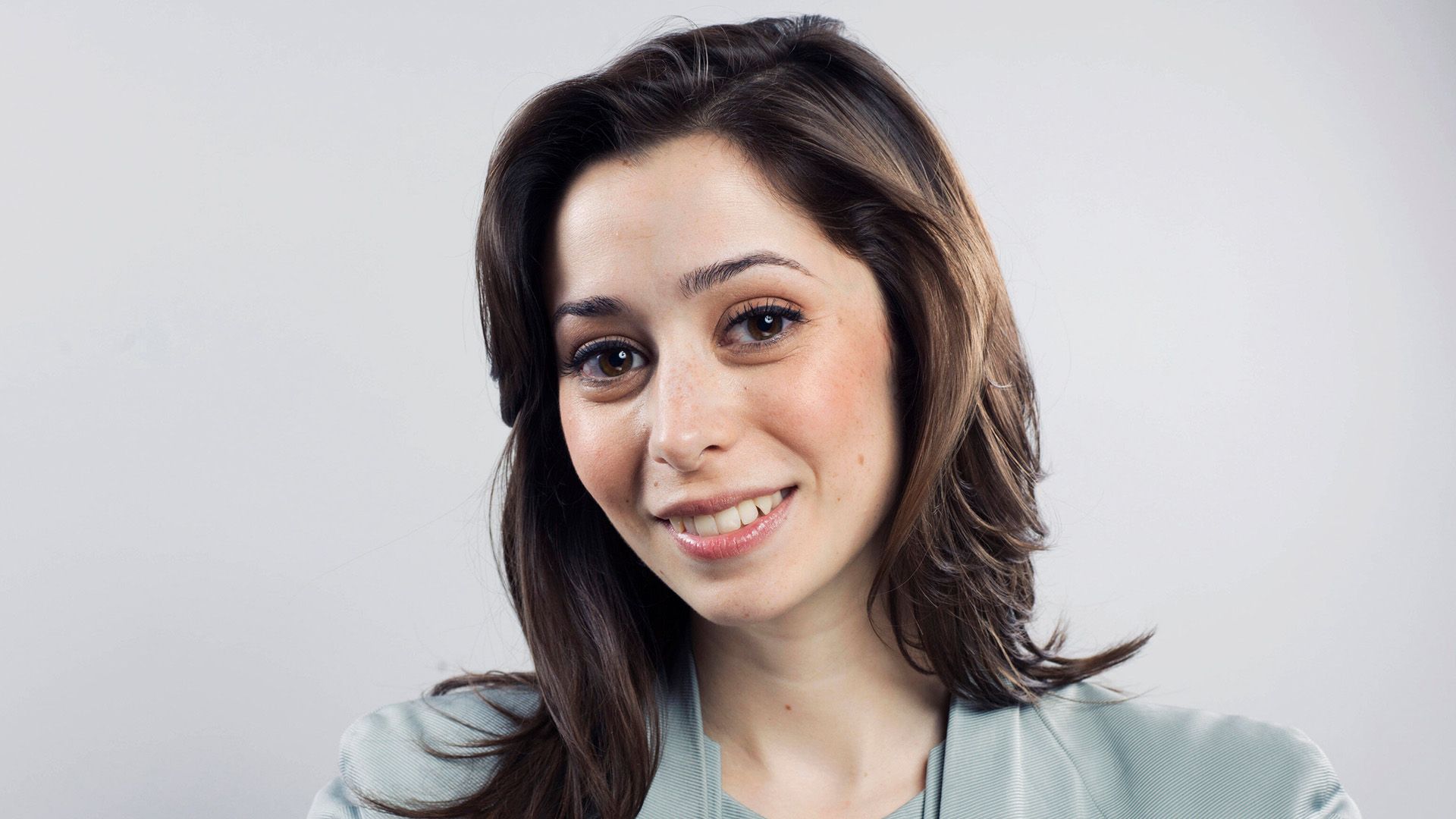Actriz Cristin Milioti con un suéter azul contra un fondo blanco