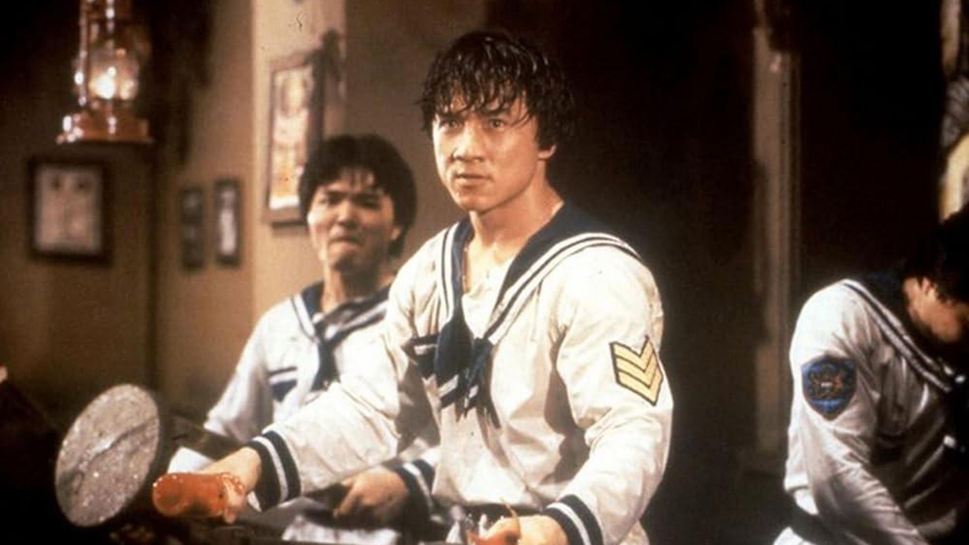 Joven Jackie Chan en un traje de marinero listo para una pelea en una escena de 'Project A'