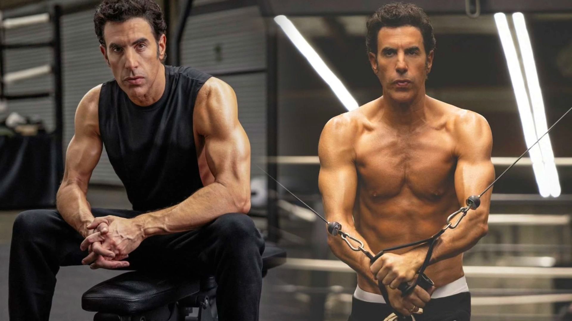 El actor Sacha Baron Cohen con una camiseta negra sin mangas muestra sus músculos tonificados, a la derecha está entrenando con equipos de ejercicio