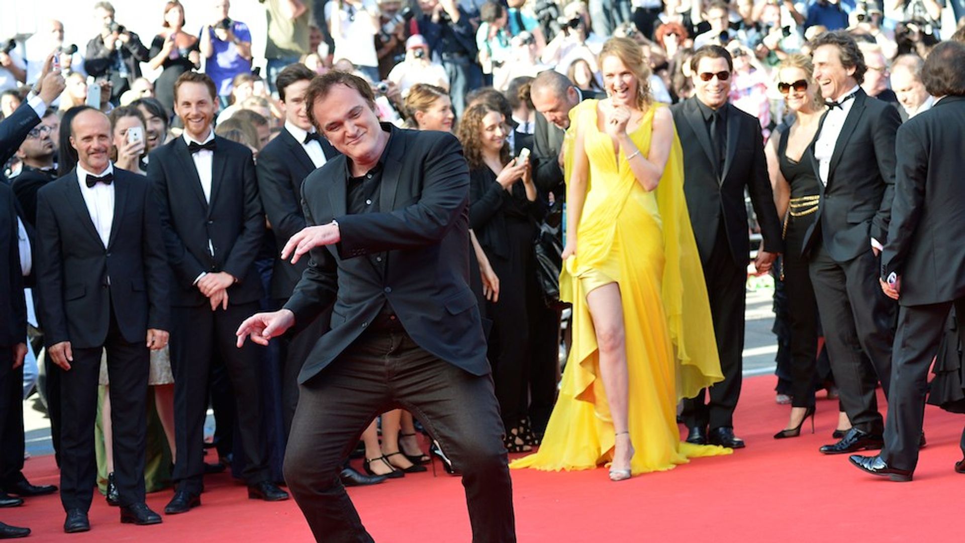 Quentin Tarantino con Uma Thurman y otras estrellas de fondo